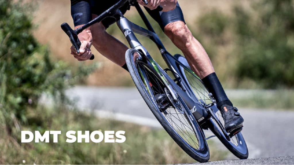 Cyclist wearing DMT cycling shoes and cornering