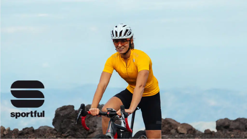 sportful woman sitting on bike on mountain