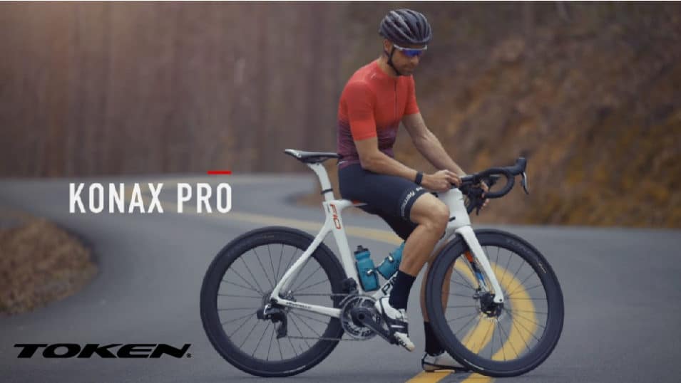 Token Wheels - Konax Pro on bike with man sitting in middle of road