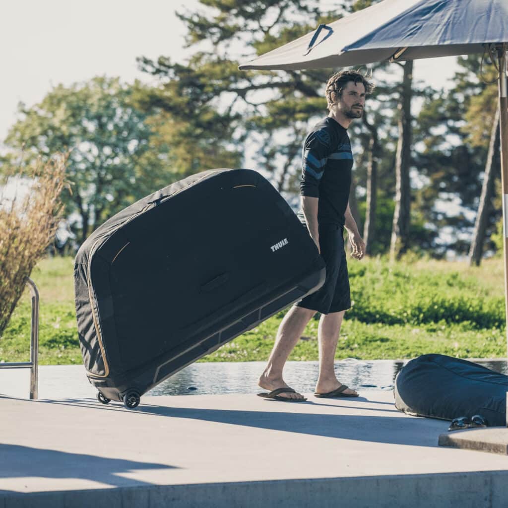 Thule Roundtrip Road Bike Travel Case pulled by man without wheel