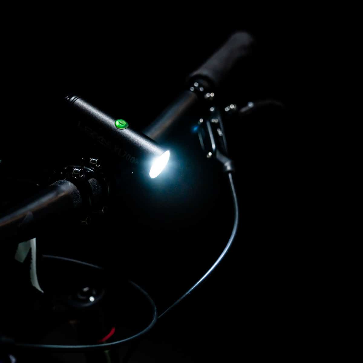 LEZYNE Classic Drive XL 700+ Light attached to handlebar with light on above