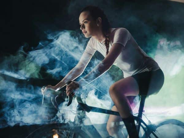 Woman indoor cycling on a bike trainer