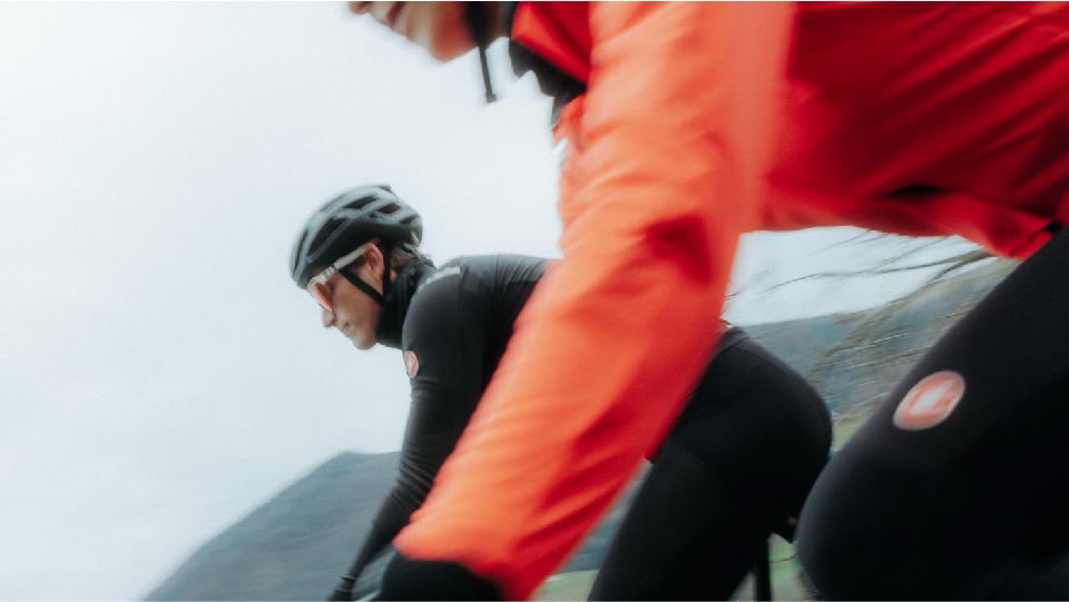 Man and woman riding in Castelli gear for cycling in cold weather