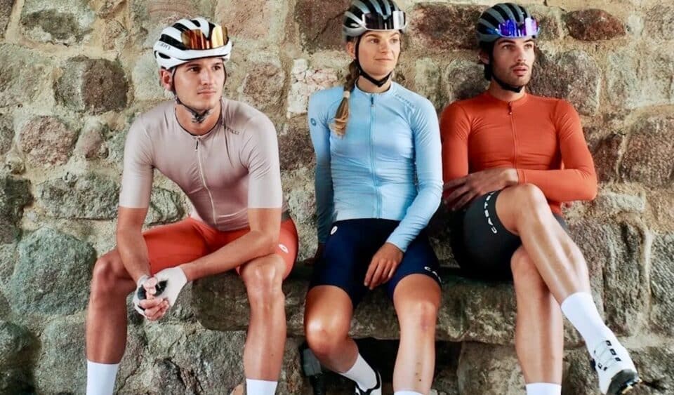Group of cyclists sitting against a stone background with Castelli Espresso 2 cycling kit